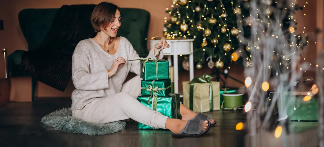 woman wearing arch support slippers and packing gifts for christmas 2025