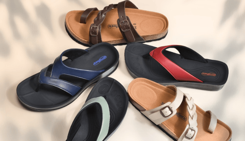 Collection of five stylish women’s orthopedic sandals arranged on a plain surface
