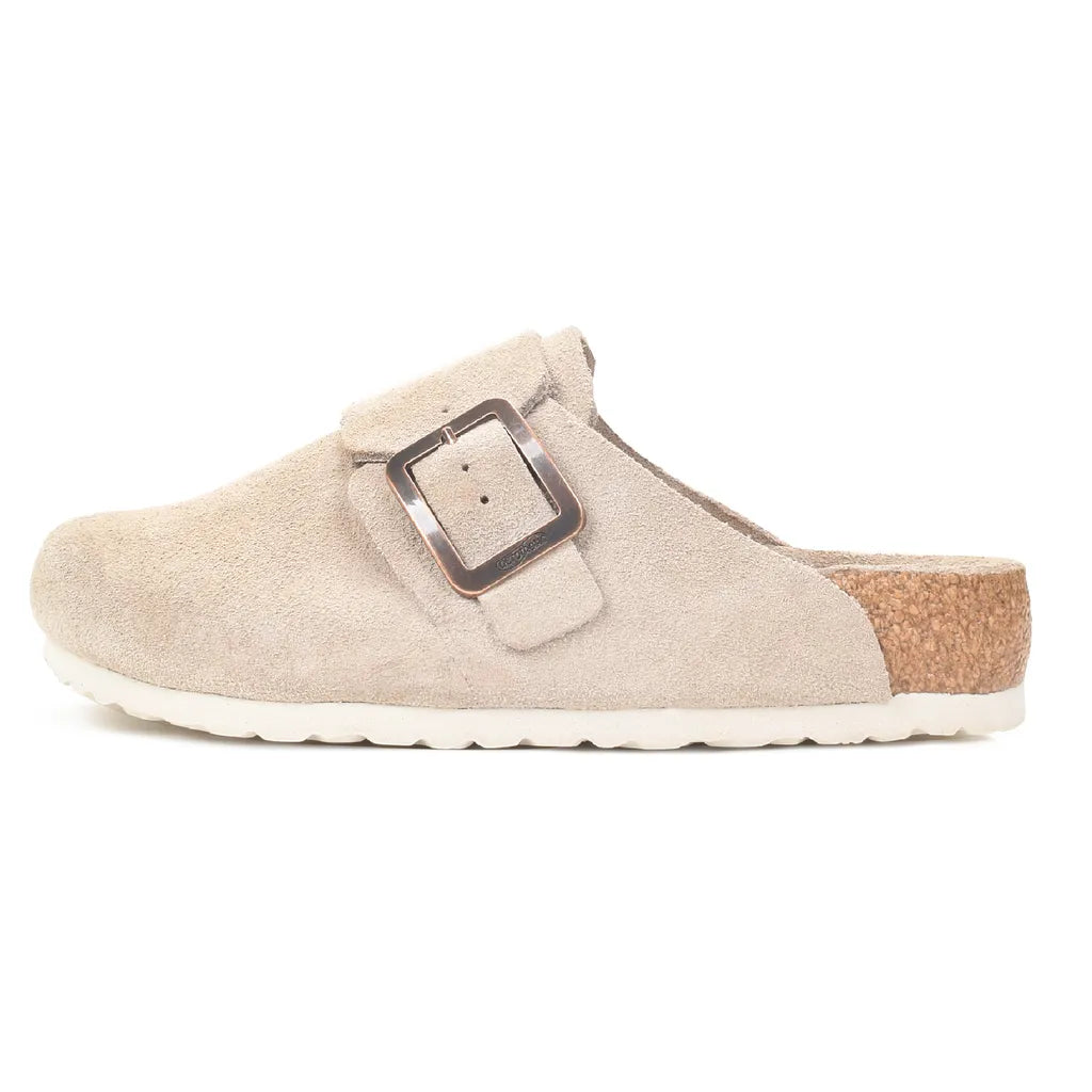 Beige Atlas clog with adjustable buckle across the instep, shown from the side