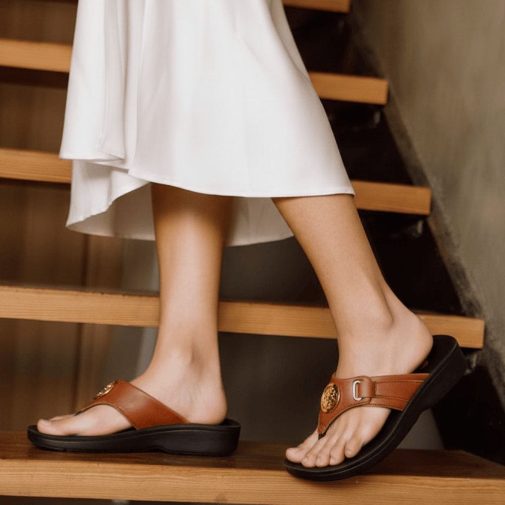Person wearing brown sandals on a wooden staircase
womens sandals with arch support
womens arch support sandals