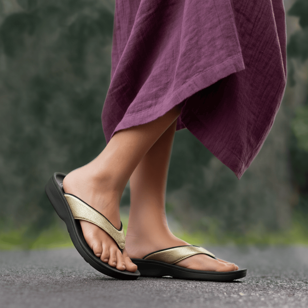 Person wearing gold sandals with a blurred background
plantar fasciitis sandals​
