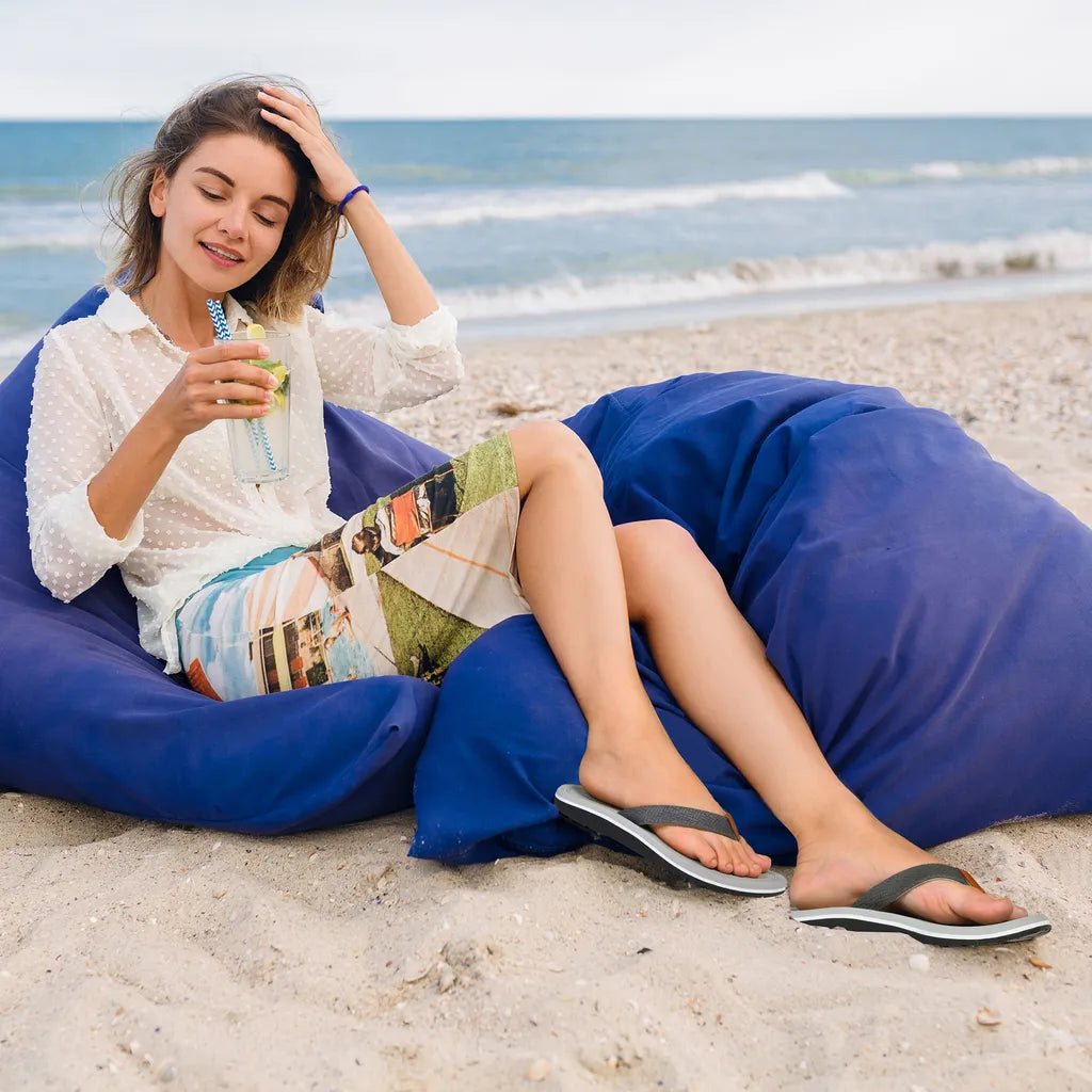Woman relaxing on a blue bean bag chair at the beach.
plantar fasciitis sandals​
sandals for plantar fasciitis​
best sandals for plantar fasciitis​